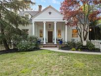 Charming white home with a columned front porch and well-manicured lawn at 582 Lakeshore Ne Dr, Atlanta, GA 30307