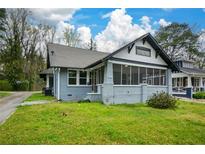 Charming single-story home featuring a screened-in front porch and a freshly painted exterior at 984 Cascade Sw Rd, Atlanta, GA 30311