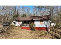 Charming home with a front porch and mature trees in a quiet neighborhood at 3291 Peachtree St, Lithia Springs, GA 30122
