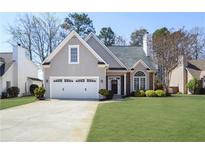 Charming home with a well-manicured lawn and two-car garage, perfect for Gathering living at 5085 Hampton Bluff Ct, Roswell, GA 30075