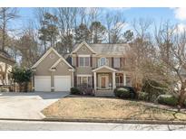 Charming two-story traditional home featuring a two-car garage and inviting front porch at 6148 Windflower Dr, Powder Springs, GA 30127