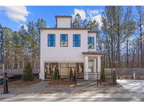 Charming two-story home with white siding, black trim, and a well-manicured front yard at 733 Stickley Oak Way, Woodstock, GA 30189