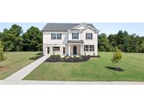 Charming two-story home boasts a lush lawn and a classic white brick and vinyl facade at 640 Kimberwick Dr, Locust Grove, GA 30248