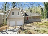 Charming home featuring a two-car garage, brick accents, and a welcoming front porch at 2339 Chevy Chase Ln, Decatur, GA 30032