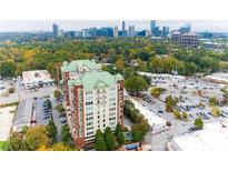 Stunning aerial view of a luxurious condo building with a vibrant city skyline backdrop at 3820 Roswell Ne Rd # 902, Atlanta, GA 30342