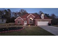 Charming brick home featuring a landscaped front yard and an attached two-car garage at 460 Greystone Ln, Douglasville, GA 30134