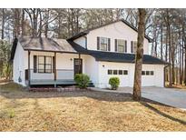 Charming two-story home features a welcoming front porch and attached two-car garage at 6730 Alvan Ct, Riverdale, GA 30296