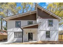 Charming two-story home featuring modern siding, black-framed windows, and a welcoming front porch at 1350 Elizabeth Sw Ave, Atlanta, GA 30310