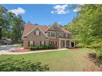 Charming two-story brick home with well-manicured lawn and inviting front porch at 140 Lost Forest Dr, Mcdonough, GA 30252