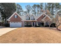 Charming brick home with a two-car garage and well-maintained lawn at 3116 Amesbury Way, Duluth, GA 30096