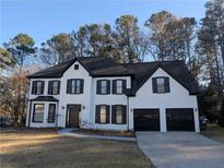 Stunning two-story home with a beautifully painted brick exterior and black trim accents at 3442 Fox Hollow Dr, Marietta, GA 30068