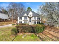 Charming two-story home with a well-maintained lawn and inviting front entrance and black shutters at 113 Willow Hill Ln, Stockbridge, GA 30281