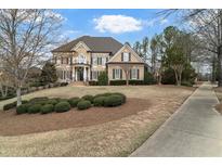 Elegant two-story home featuring a balcony, manicured lawn, and welcoming entrance at 19 Troup Ct, Acworth, GA 30101
