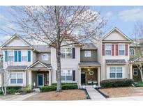 Charming townhomes featuring manicured landscaping, covered entrances, and diverse architectural details at 2449 Suwanee Pointe Dr, Lawrenceville, GA 30043