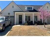 Charming home with white columns, a well-manicured lawn, and a blooming tree at 5099 Noble Village Way, Lilburn, GA 30047