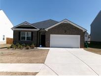Charming single-story home with a brick facade and a two-car attached garage at 120 Montgomery Dr, Stockbridge, GA 30281