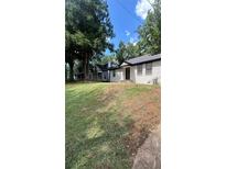 Charming single-story home with manicured lawn and mature trees providing shade and curb appeal at 1735 Derry Sw Ave, Atlanta, GA 30310
