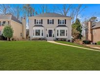 Traditional two-story home featuring black shutters, bay windows, and a lush green lawn at 2018 Sugar Maple Ln, Woodstock, GA 30189