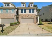 Attractive townhome with stone accents, a two-car garage, and well-maintained landscaping at 372 Mulberry Se Row, Atlanta, GA 30354