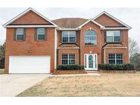 Charming two-story brick home with an attached two-car garage and well-manicured landscaping at 4970 Wewatta Sw St, Atlanta, GA 30331