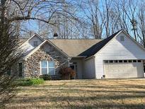 Charming single-Gathering home featuring stone accents and a two-car garage at 7925 Timberline Overlook, Cumming, GA 30041