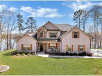 Charming two-story brick home with manicured lawn and inviting front porch at 180 Allie Dr, Mcdonough, GA 30252