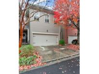 Charming two-story townhome with a well-manicured lawn and a two-car garage, perfect for suburban living at 2232 W Village Junction Way, Smyrna, GA 30080