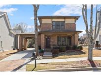 Charming two-story brick home with a covered porch, walkway, and a well-manicured front yard at 1917 Baxley Pine Trce, Suwanee, GA 30024