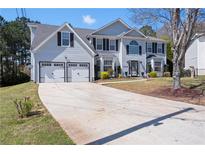 Charming two-story home with a well-manicured lawn, two car garage, and inviting entrance at 1979 Resting Creek Dr, Decatur, GA 30035