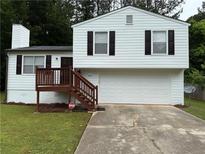 Charming split-level home with a two-car garage, a wood deck, and a well-maintained front yard at 1848 San Gabriel Ave, Decatur, GA 30032