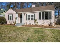 Charming pink brick home featuring dark shutters, green lawn, and a screened in porch at 1810 S Gordon Sw St, Atlanta, GA 30310