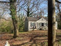 Charming single-story home with traditional design elements nestled in a wooded lot with mature trees at 2648 Joyce Ave, Decatur, GA 30032