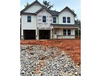 New construction home featuring two-car garage, covered porch, and unfinished landscaping at 740 Great Oak Pl, Villa Rica, GA 30180