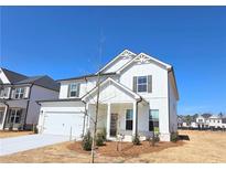 Charming new construction home features white siding, black shutters, and a welcoming front porch at 2714 Mourning Dove Drive (33), Grayson, GA 30017