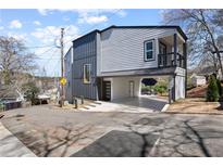 Contemporary home with gray siding, covered parking, balcony, and unique architectural design at 42 Riverdale Cir, Canton, GA 30114