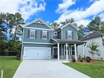 Charming two-story home with a two-car garage and well-maintained lawn at 2704 Mourning Dove Dr Lot 34, Grayson, GA 30017