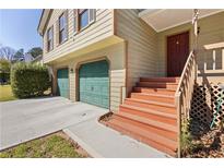 Charming home featuring a two-car garage, painted trim, and covered front porch at 1312 Brandl Sw Dr, Marietta, GA 30008