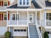Charming townhome with a welcoming front porch and attached garage at 2024 Oakley Se Trce, Smyrna, GA 30080