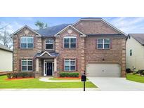 Charming two-story brick home with a well-manicured lawn and attached two-car garage at 2897 Austin Common Dr, Dacula, GA 30019