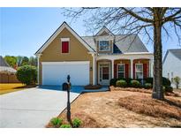 Charming home with a well-maintained lawn, red shutters, and inviting front porch at 303 Dexter Dr, Woodstock, GA 30188