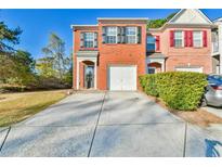 Charming two-story brick home with a one-car garage and a well-manicured lawn, perfect for families at 1526 Viero Dr, Lawrenceville, GA 30044