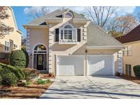 Charming two-story home featuring a two-car garage and beautifully landscaped front yard at 1056 Shady Valley Ne Pl, Brookhaven, GA 30324