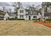 Charming two-story home with white brick, black shutters, an American flag, and a well-maintained front lawn at 2885 Alpine Ne Rd, Atlanta, GA 30305