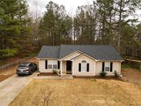 Charming single-story home featuring a well-maintained lawn, dark-shuttered windows, and a private driveway at 284 Southern Trace Way, Rockmart, GA 30153