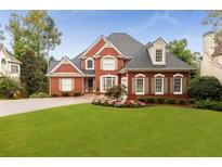 Lovely two-story brick home with manicured lawn and beautiful flower beds in a desirable neighborhood at 1009 Fairway Seven, Villa Rica, GA 30180