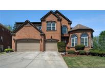Beautiful two-story brick home featuring a three-car garage and manicured landscaping at 6016 Southland Dr, Stone Mountain, GA 30087