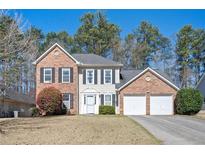 Charming two-story brick and siding home with a well-manicured lawn and attached two-car garage at 3090 Perch Overlook Sw, Marietta, GA 30008