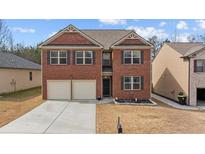 Charming two-story brick home with a two-car garage and well-maintained landscaping at 6028 Providence Dr, Union City, GA 30291