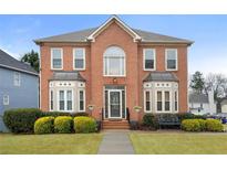 Charming brick two-story home featuring bay windows, manicured landscaping and a welcoming front porch at 2605 Jacobean Rd, Acworth, GA 30101