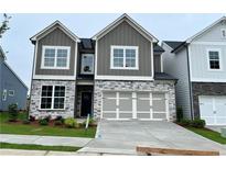 Charming new construction two-story home with stone accents and a two-car garage at 274 Lakeside Pl, Canton, GA 30114